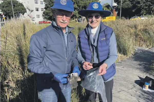 Rotarians Dennis Small and Paula McKnight on waterfront rodent patrol